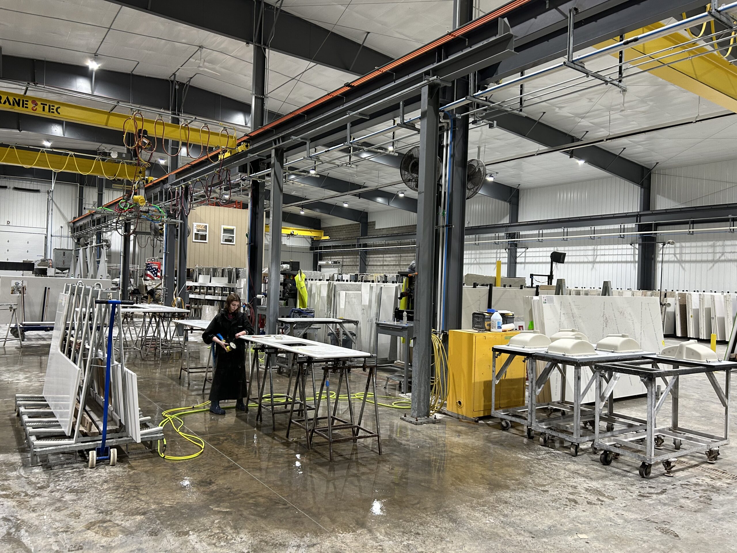 Stone countertop fabrication work moving through a production shop