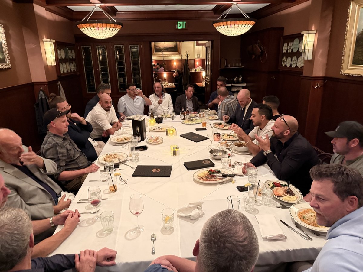 Attendees seated around a dinner table.